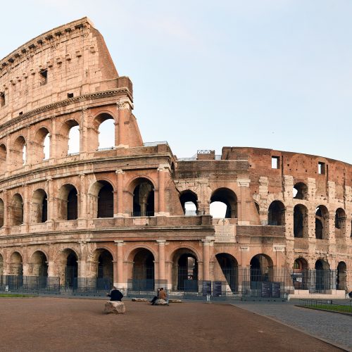 The Roman Colosseum lit by warm evening light The Roman Colosseum lit by warm evening light