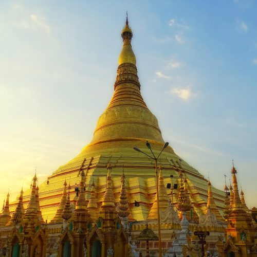 The gilded Shwedagon Pagoda glowing at dusk in Yangon, Myanmar The gilded Shwedagon Pagoda glowing at dusk in Yangon, Myanmar