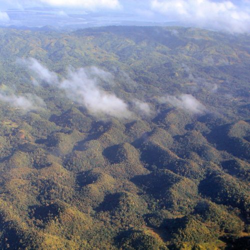 The Chocolate Hills of Bohol, Philippines, under a blue sky The Chocolate Hills of Bohol, Philippines, under a blue sky
