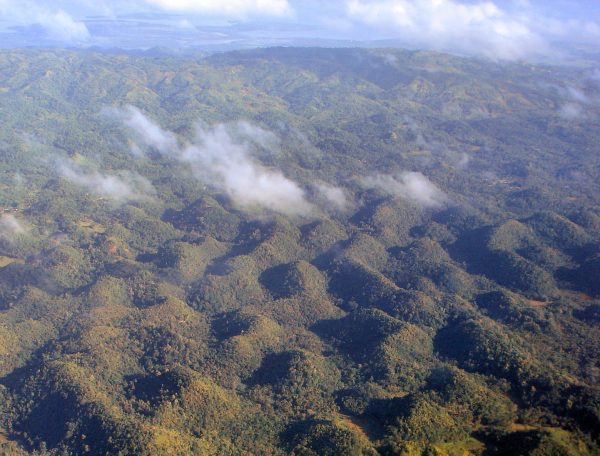 The Chocolate Hills of Bohol, Philippines, under a blue sky The Chocolate Hills of Bohol, Philippines, under a blue sky