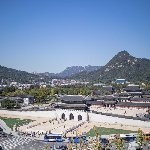 Gyeongbokgung Palace gate in Seoul with traditional hanbok visitors Gyeongbokgung Palace gate in Seoul with traditional hanbok visitors