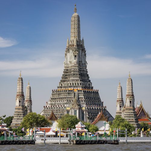 Wat Arun temple spires on the Chao Phraya River at sunset in Bangkok Wat Arun temple spires on the Chao Phraya River at sunset in Bangkok