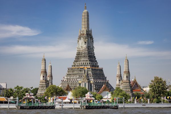 Wat Arun temple spires on the Chao Phraya River at sunset in Bangkok Wat Arun temple spires on the Chao Phraya River at sunset in Bangkok